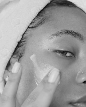 Applying moisturizer, close crop.